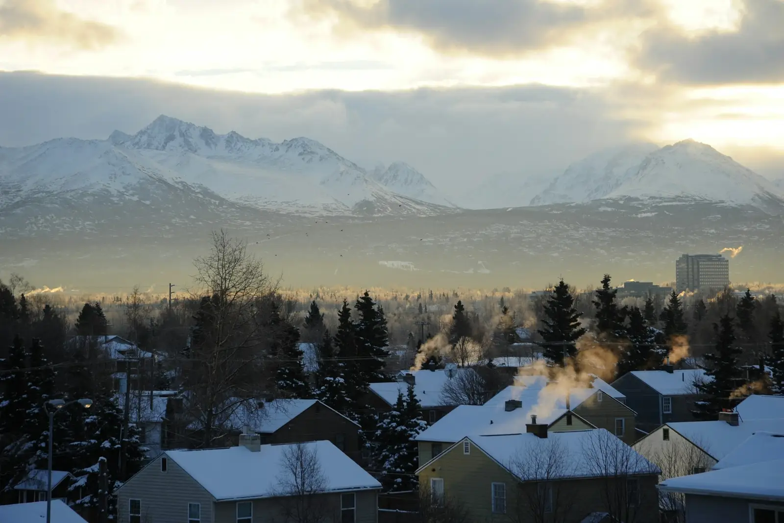 Anchorage homes in snow below the Chugach Mountains