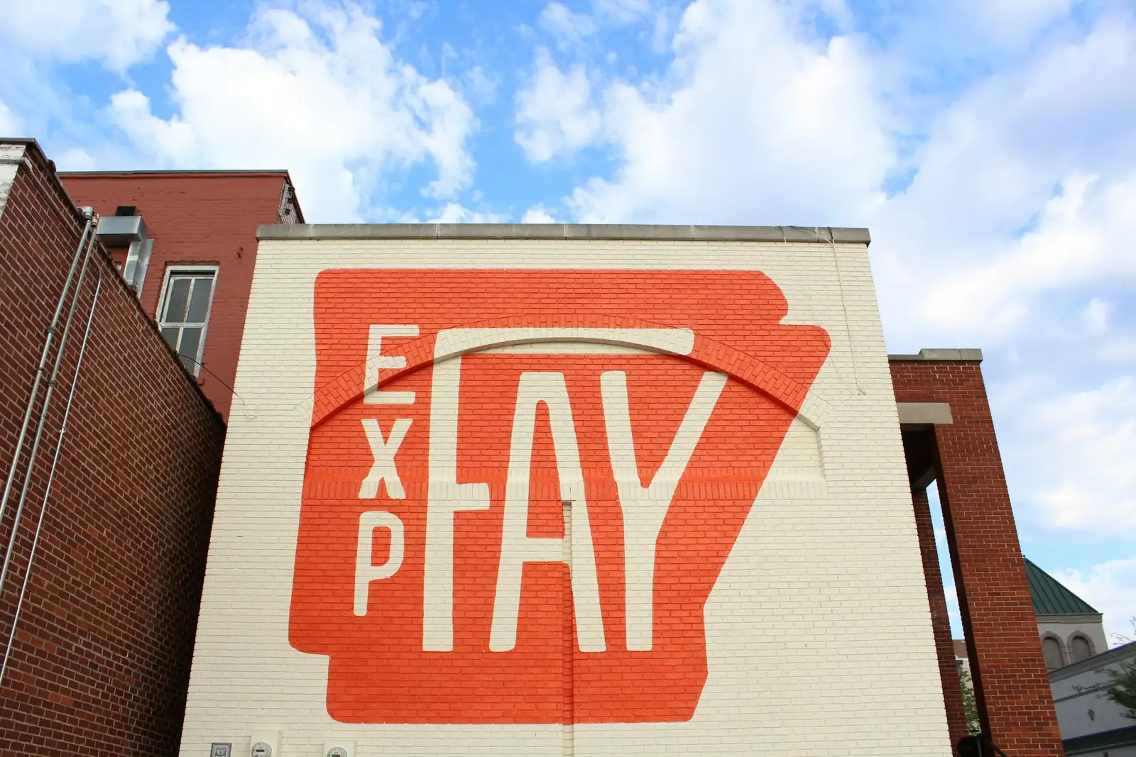 A painted Fayetteville mural on a downtown brick building in Fayetteville, Arkansas
