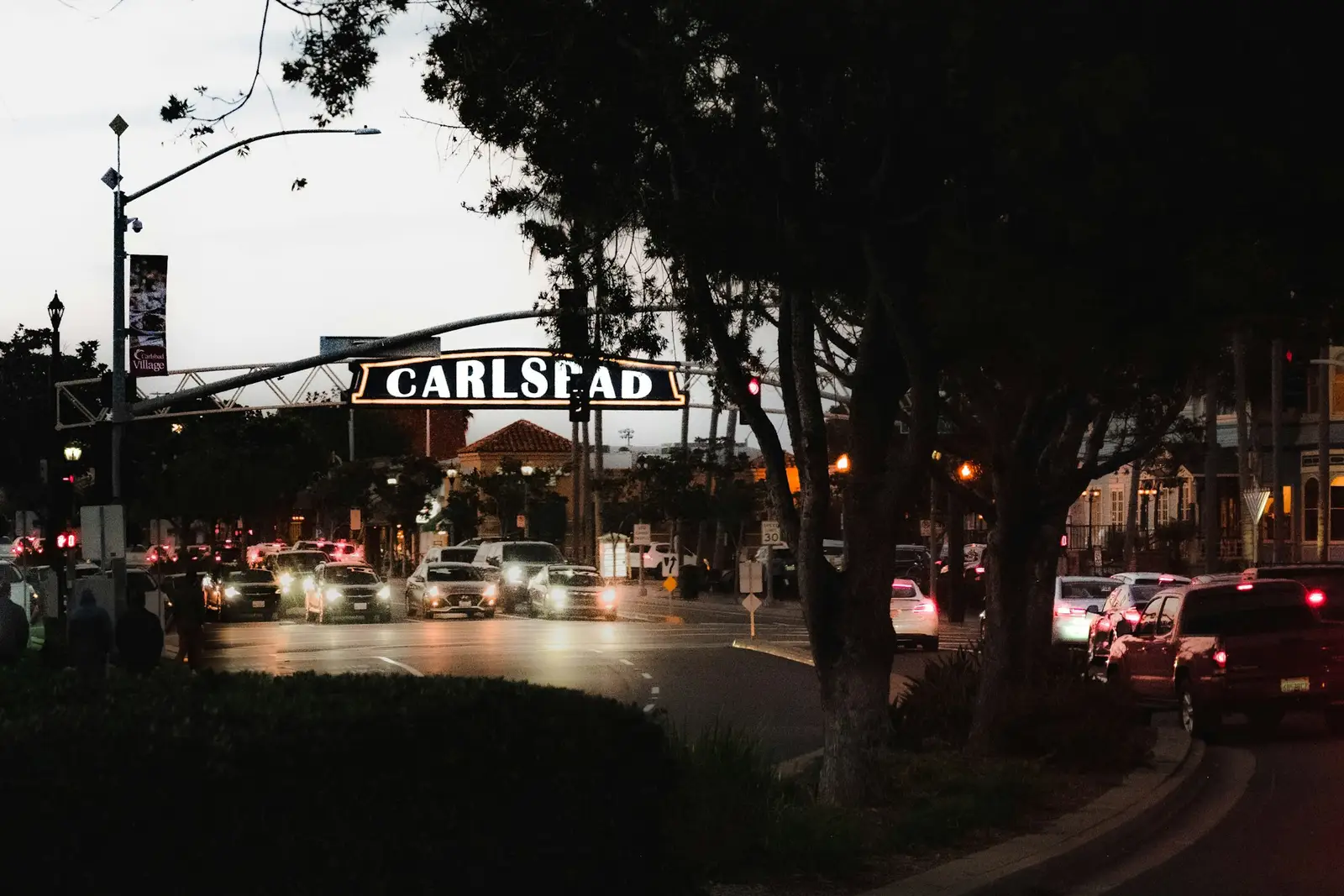 Carlsbad village sign over the street at dusk