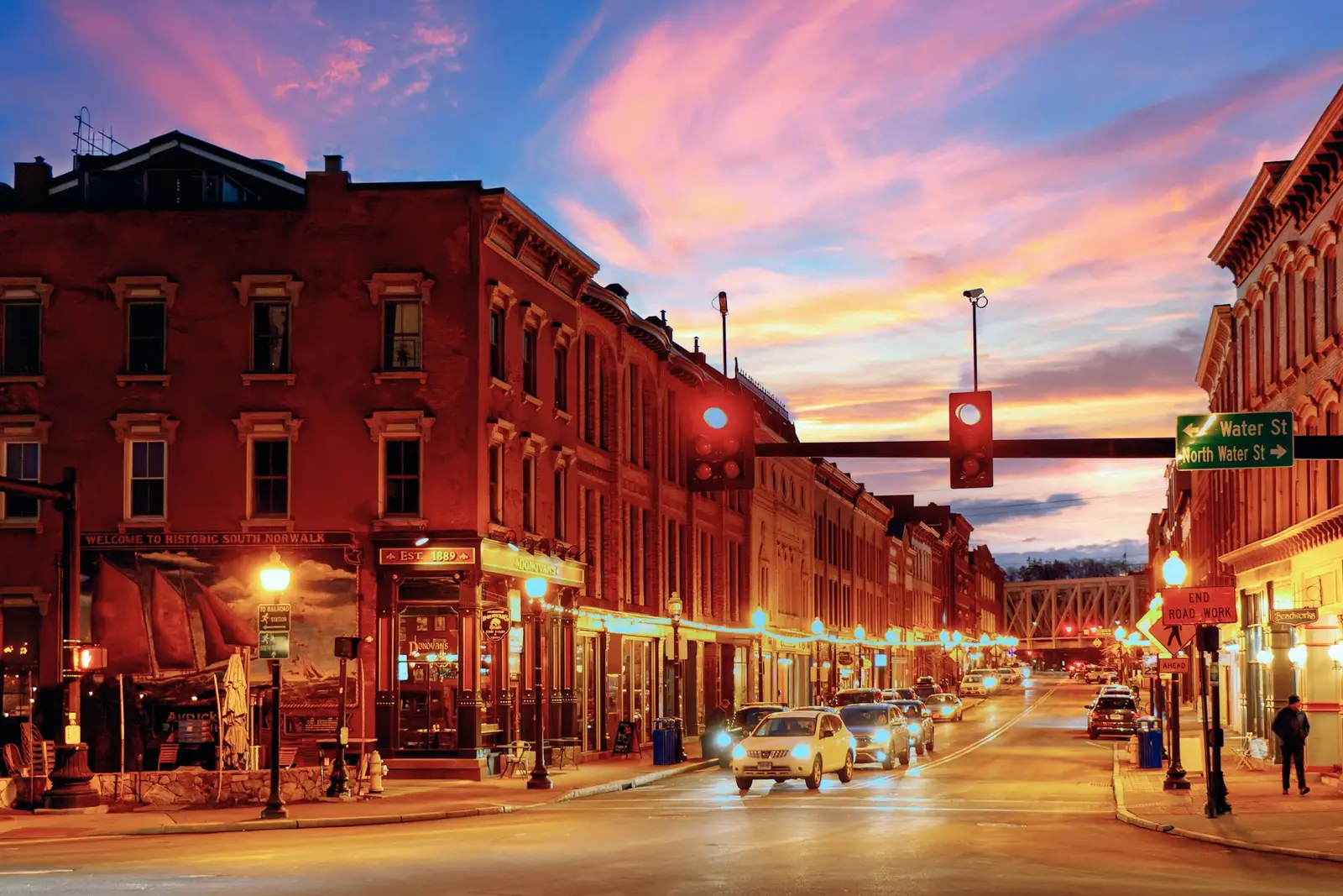 Brick storefronts along Washington Street in South Norwalk at dusk