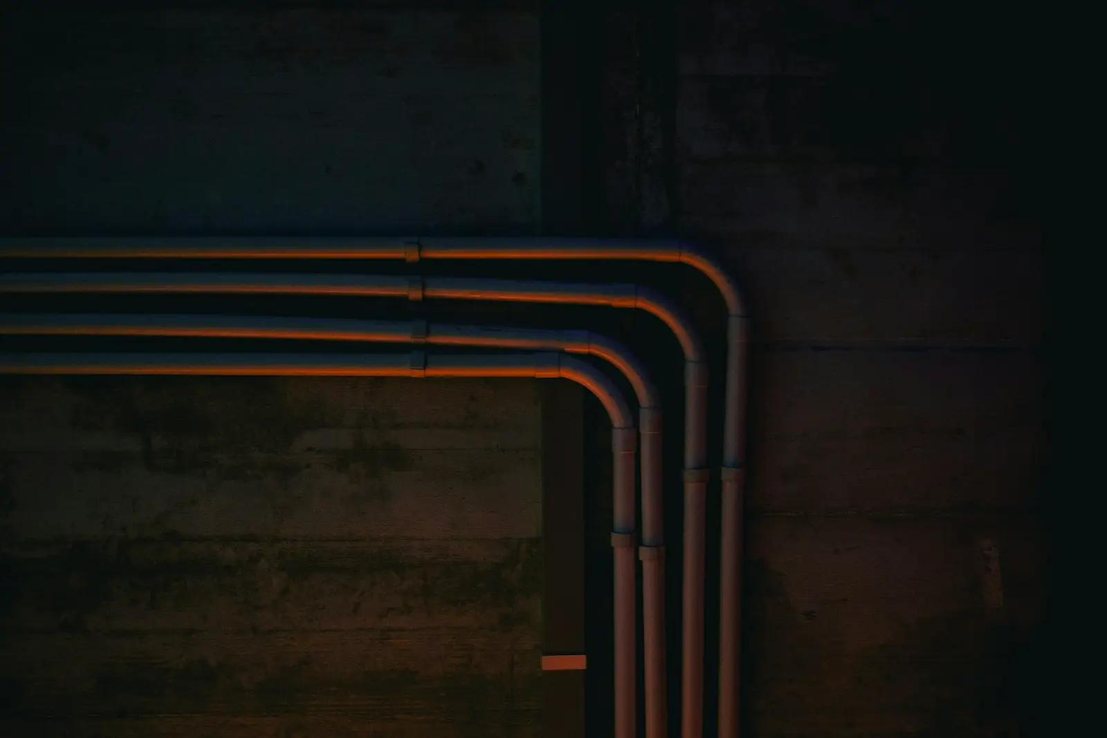 Copper pipes running along a wall