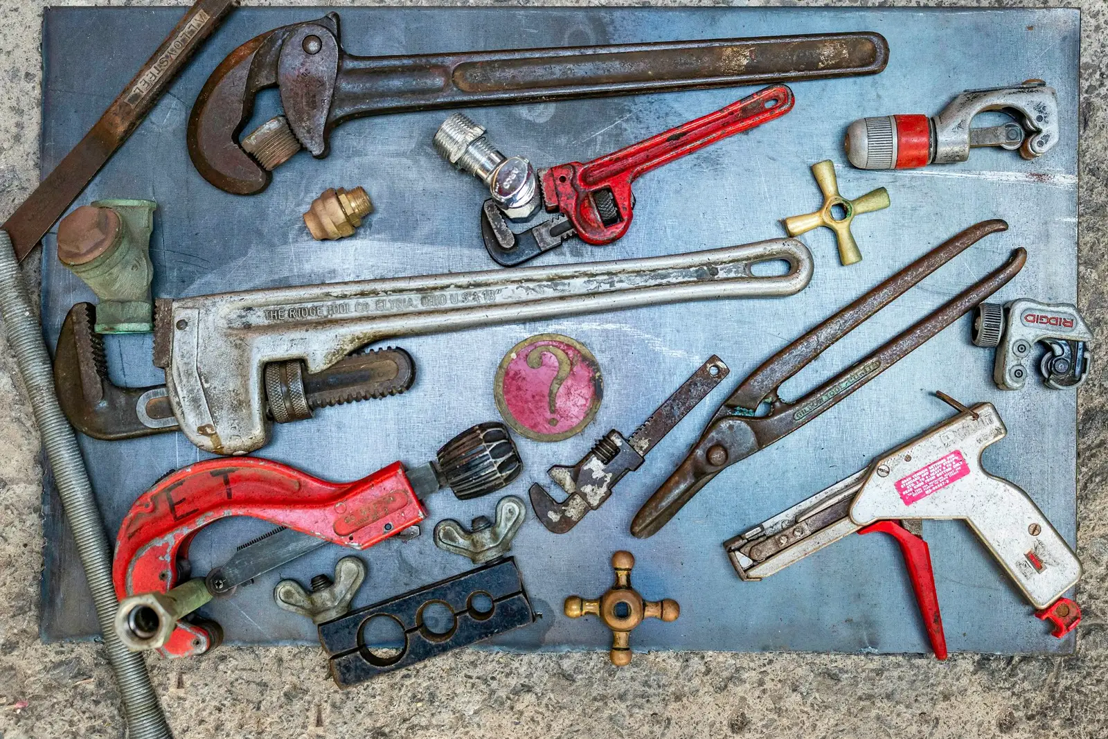 Plumbing tools laid out on a workbench