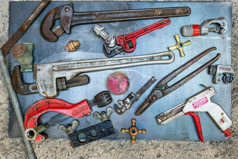 Plumbing tools laid out on a workbench