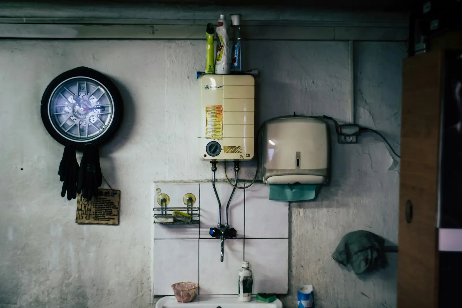 Wall-mounted water heater in a tiled room