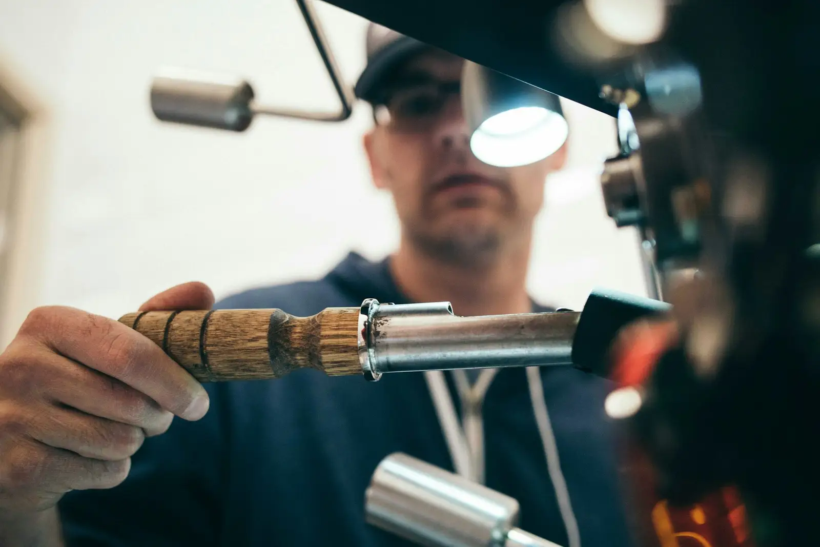 Plumber using a tool on a pipe fitting