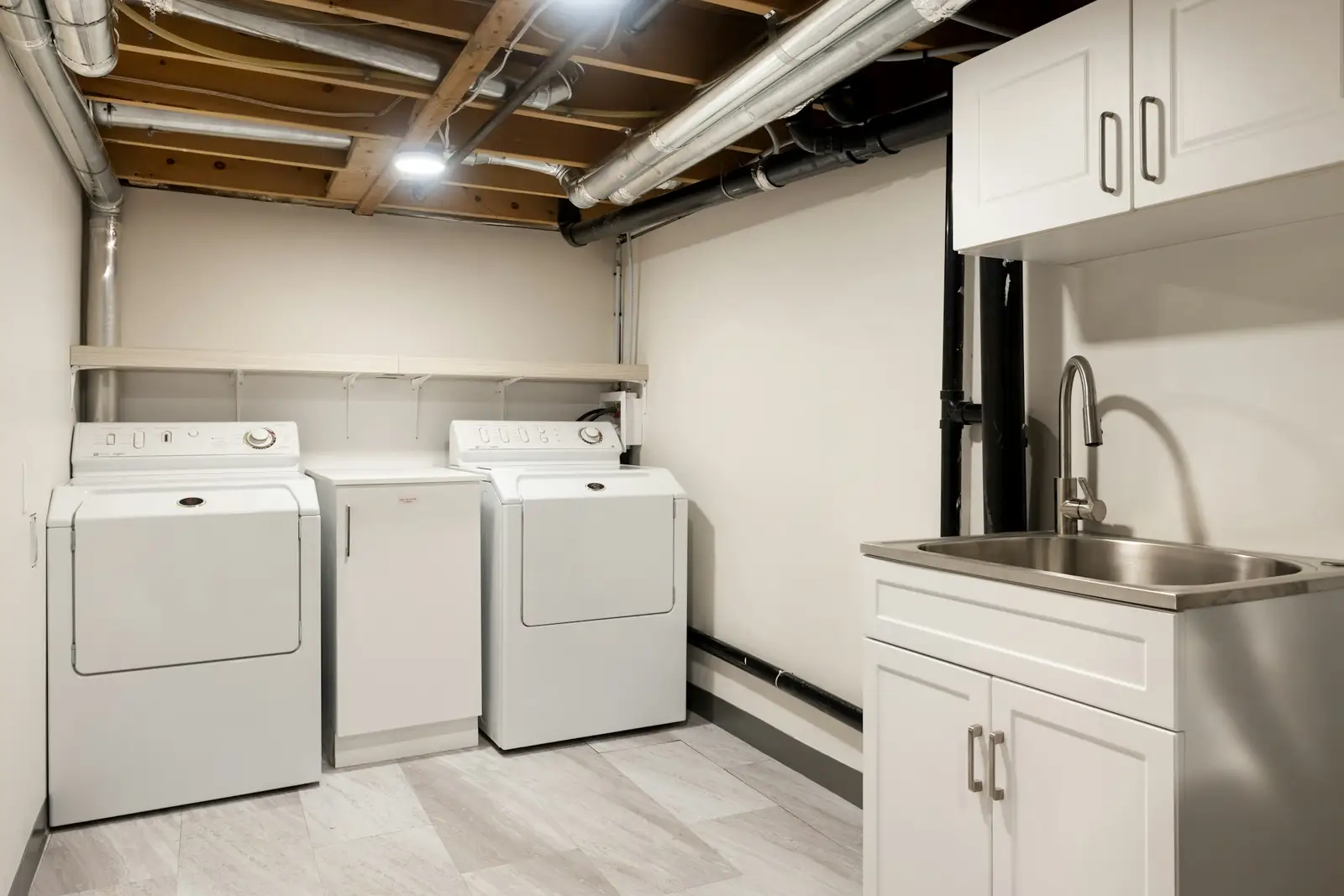 Basement utility room with pipes and laundry